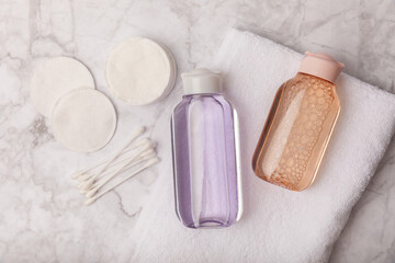 Micellar water, make-up remover with cotton pads. TONIC. Skin cleansing from sebum and makeup. Composition on a white marble background. Beauty concept. Copy space text. flat lay