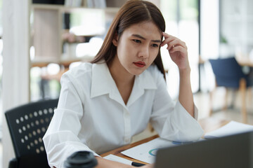 Portrait of sme business owner, woman using computer and financial statements Anxious expression on expanding the market to increase the ability to invest in business