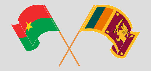 Crossed and waving flags of Burkina Faso and Sri Lanka