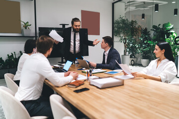 Dissatisfied male executive manager discussing business strategy with coworkers