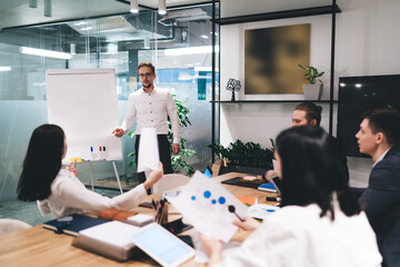 Group of colleagues listening to presentation in office