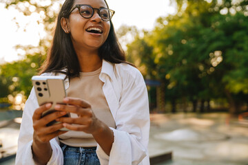 Portrait of young beautiful smiling long-haired african girl in glasses
