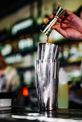 man bartender making cocktail in bar.