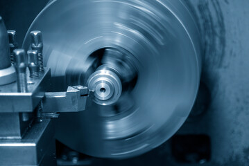 The lathe machine finish cut the metal shaft parts by lathe tools.
