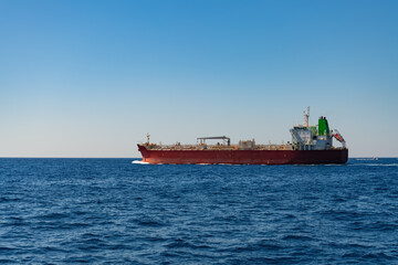 Oil or chemical tanker on a sunny day on the mediterranean sea. Red vessel on its way to next port...