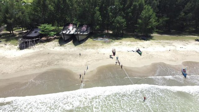 People pull the trawler.
