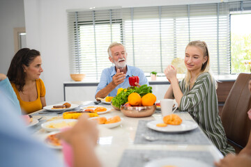 Photo of big family at home, people sit feast dishes table around roasted turkey multi-generation relatives making group with food and pizza in house living room indoors