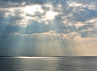 Sunshine shinning through the clouds onto the Mediterranean sea in Nice, France.
