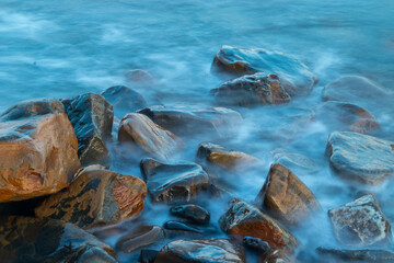 Stones in sea water. Waves on long exposure