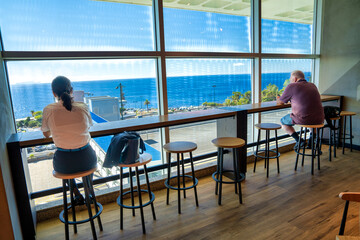 Madeira, Portugal - September 8, 2022: Tourists enjoy the view from the airport window