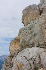 Stone giant hidden in the cliff face of a mountain