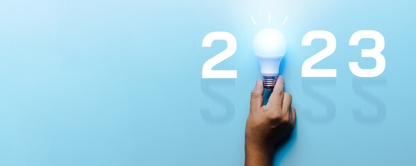 Idea and creative in 2023, lighting bulb with new year number on blue background