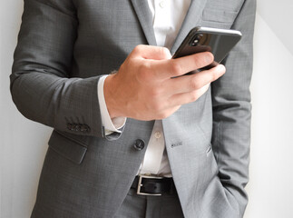 Midsection of businessman holding a mobile phone