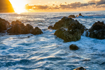 Waves crushing on the rocks at sunset - Long exposure