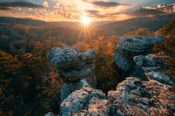 Arkansas Pedestal Rocks overlooking the Ozark Mountains in Autumn during a colorful sunset in the St. Francis forest. 