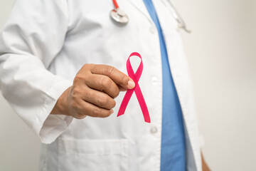 Breast cancer, Asian doctor woman with pink ribbon, symbol of World Breast Cancer Day.