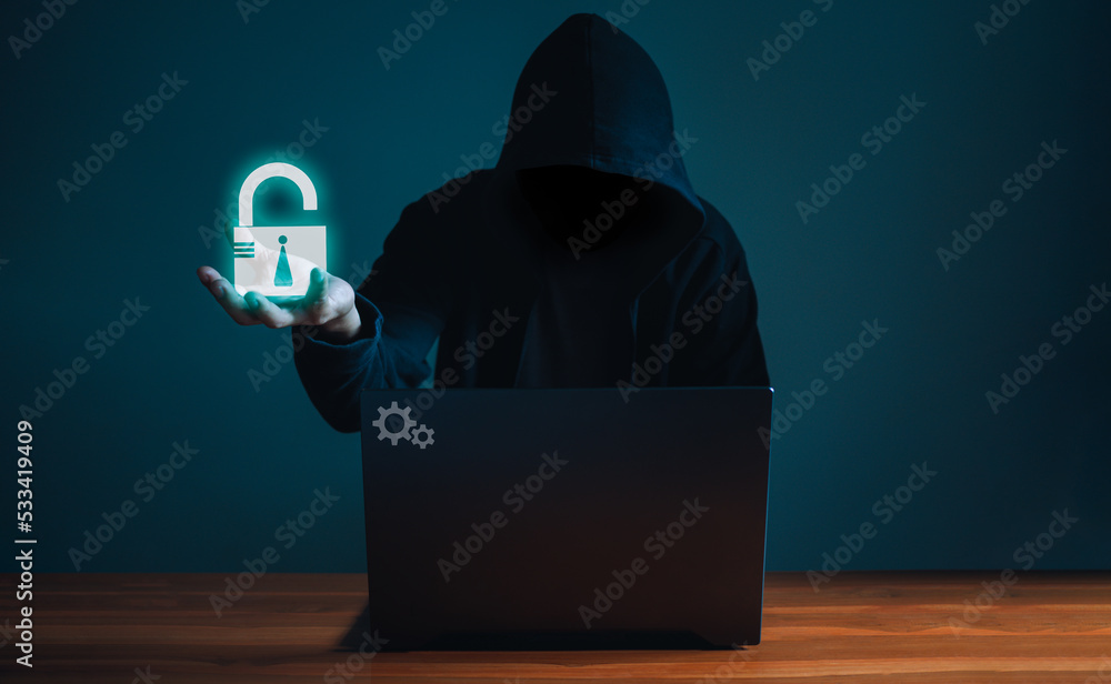 Poster hackers work on laptops in the dark. the concept of information security in the internet network and
