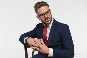 stylish elegant man with glasses posing in a fashion manner