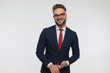 handsome elegant man wearing red tie and navy blue suit and smiling