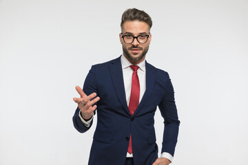 handsome businessman with glasses being confident and gesturing