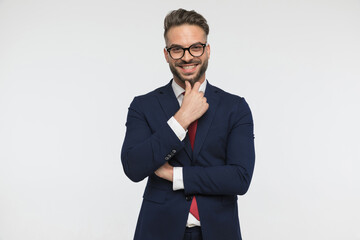 smiling elegant man touching chin and thinking, being happy