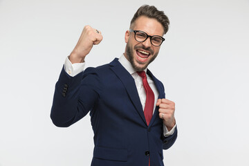 excited businessman with fists in the air celebrating victory
