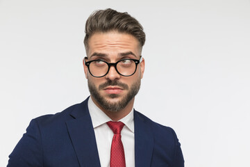 confused businessman with glasses looking up and wondering