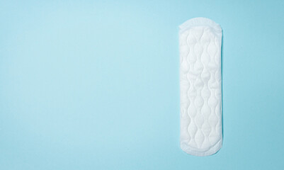 Sanitary pads are lying on a light blue background. Menstrual cycle and pregnancy. Negative pregnancy test and contraceptives