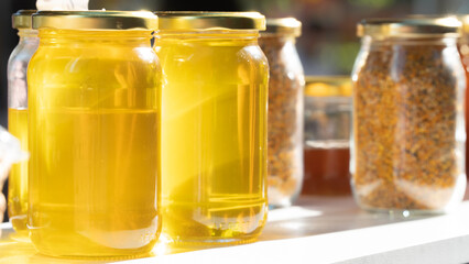 Fototapeta na wymiar Glass jars with honey and propolis, canned food