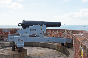 Fototapeta na wymiar Vintage canons line the walls of Southsea Castle near Portsmouth in the United Kingdom.