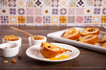 Honey or maple syrup roast pears with walnuts. Vegetarian diet health delicious dessert.