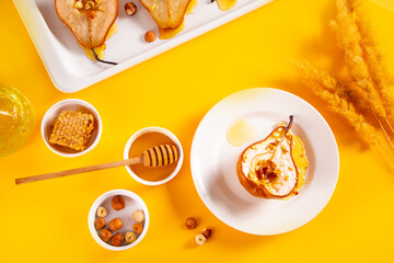 Honey or marple syrup roast pears with walnuts. Vegetarian diet health delicious dessert.