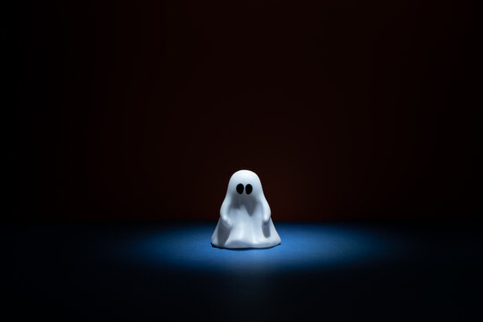 Toy Ghost Centered On Small Stage With Overhead Light