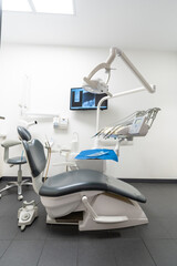 Modern dental practice. Dental chair, medical light, dental clinic without people. vertical photo