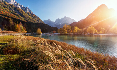 Stunning nature scenery in Slovenian Alps. Incredible autumn landscape on Jasna lake. Triglav national park. Kranjska Gora, Slovenia. Amazing landscape with mountain lake at sunset