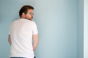Shameless man urinating on the wall of the house or masturbates, looking around in fear and...