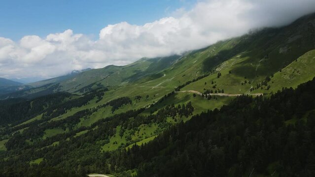 panorama of mountain peaks with clouds in summer in teberda shot on a drone