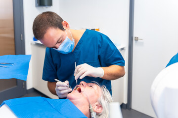 Dental clinic, elderly woman at dentist checking implants with dentist doctor, face mask