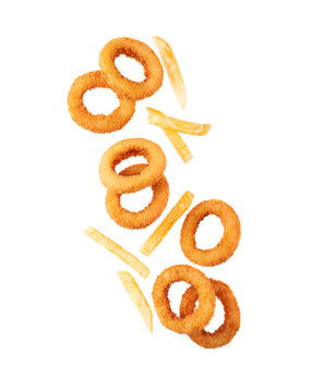 Flying fried potatoes and onion rings. Fast food