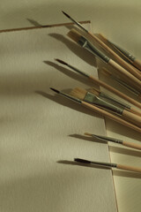 set of paint brushes and white paper