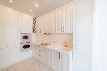 Fototapeta na wymiar new clean white kitchen with light furniture