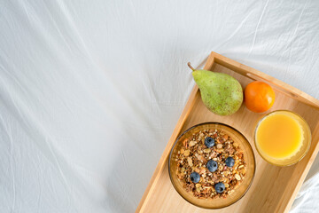 breakfast on a tray, breakfast in bed, muesli and fruit and fresh juice, space for text