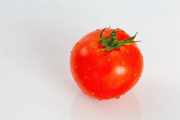 Close up shot of red tomato with water drops