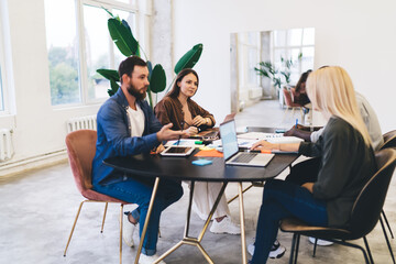 Group of diverse people using gadgets in meeting room