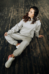 Attractive sexy woman wear warm total look. Girl look preaty. Elegant look. Brunette model wear hoody. Winter, fall autumn or spring minimal outfit. Woman is sensual.