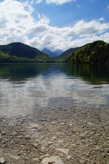 gorgeous emerald-green lake Alpsee in the German Alps in Hohenschwangau near castles Hohenschwangau and Neuschwanstein, Allgau, Bavaria, Germany