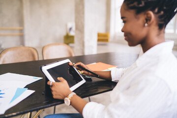 African American woman working on tablet in office