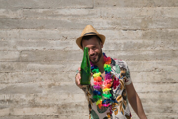 Young and handsome man, blue eyes, with beard, hat, Hawaiian shirt and flower necklace and offering...