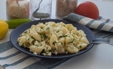 Pasta with cheese on a black plate. Italian Popular Italian food.