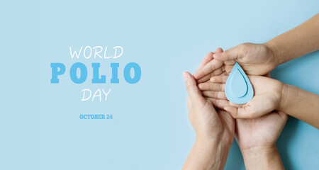 World Polio day. October 24. Blue drop in hands of an adult and child is symbol of polio vaccine. Poliomyelitis is disabling and life-threatening disease caused by poliovirus - obrazy, fototapety, plakaty